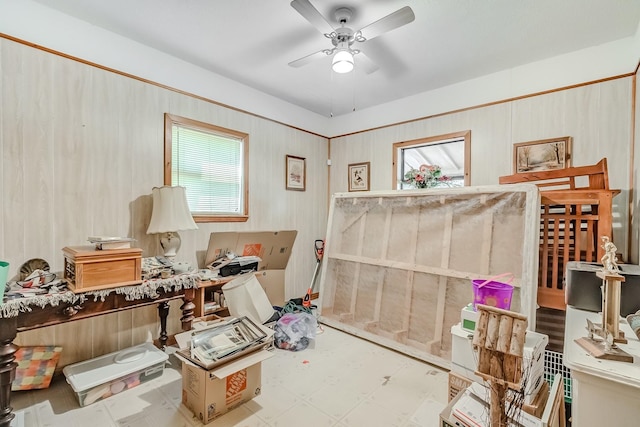 interior space with ceiling fan
