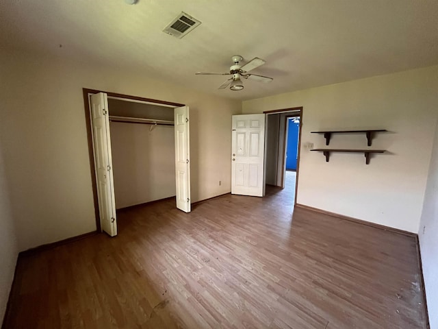 unfurnished bedroom with wood finished floors, baseboards, a closet, and ceiling fan