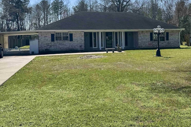 single story home with driveway, a shingled roof, a front lawn, a carport, and brick siding