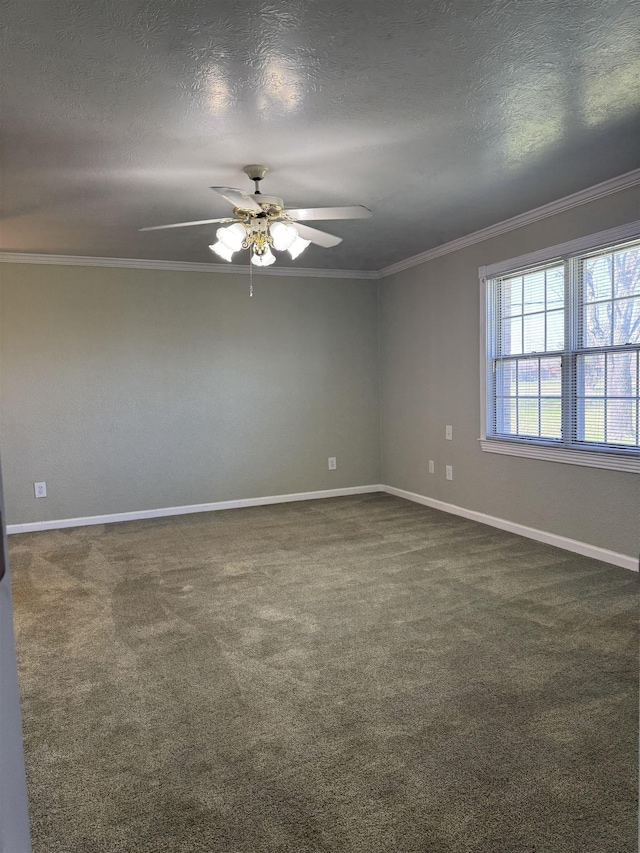 empty room featuring dark carpet, a textured ceiling, crown molding, and baseboards