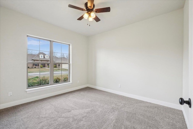 unfurnished room with ceiling fan and carpet