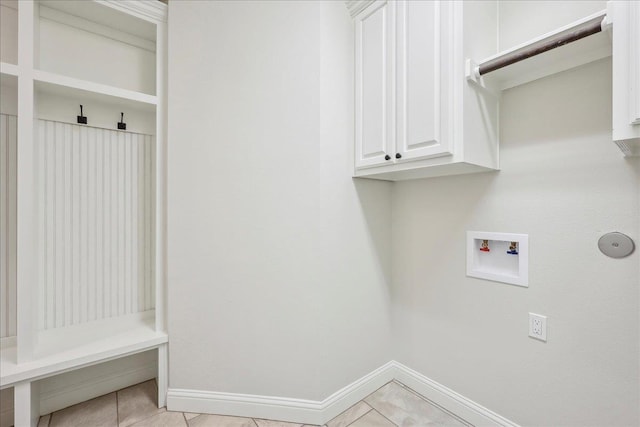 laundry area with cabinets, washer hookup, and light tile patterned floors