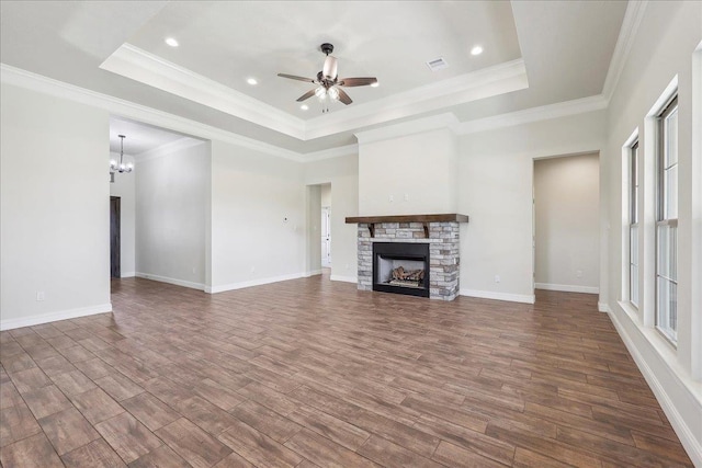 unfurnished living room with dark hardwood / wood-style flooring, a fireplace, and a raised ceiling