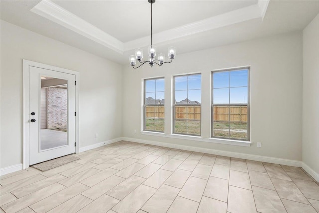 unfurnished dining area featuring an inviting chandelier and a raised ceiling