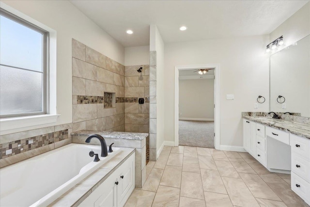 bathroom featuring vanity and separate shower and tub