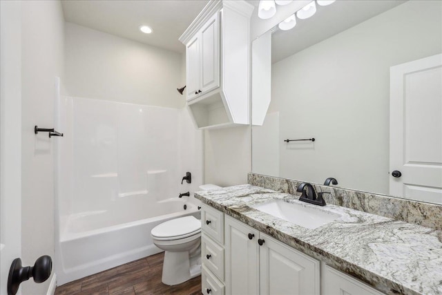 full bathroom with toilet, wood-type flooring, bathtub / shower combination, and vanity