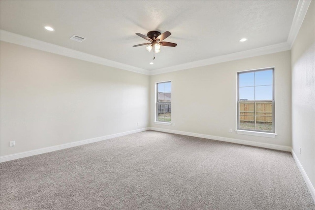 carpeted empty room featuring ornamental molding and ceiling fan