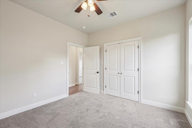 unfurnished bedroom featuring ceiling fan, carpet flooring, and a closet