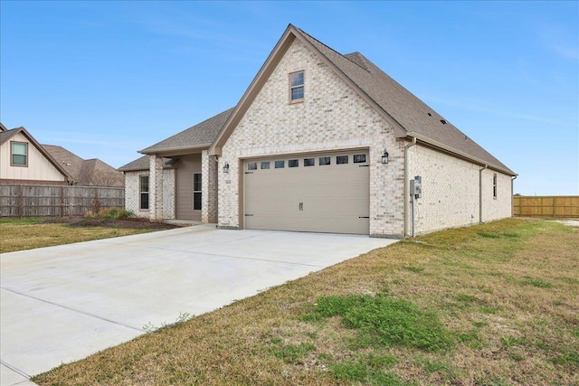 view of front of house with a garage and a front yard