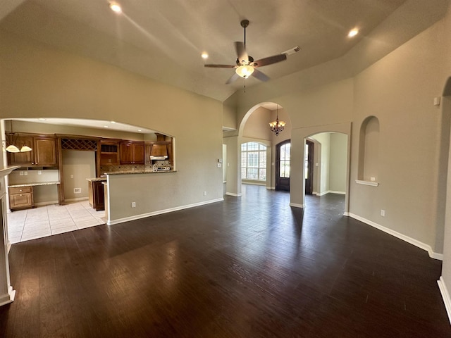 305 Tyler Dr, Bridge City, TX 77630 - unfurnished living room with arched walkways, wood finished floors, ceiling fan, recessed lighting, and baseboards