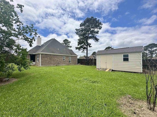 305 Tyler Dr, Bridge City, TX 77630 - view of yard with a storage unit and an outbuilding
