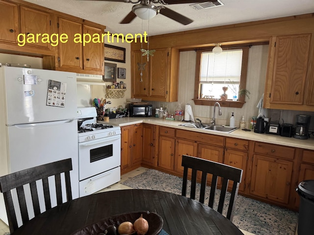 kitchen with ceiling fan, white appliances, and sink