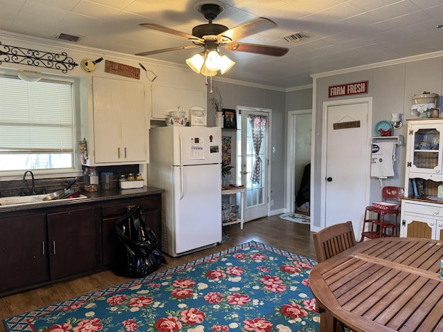 kitchen with crown molding, white fridge, sink, and dark hardwood / wood-style floors