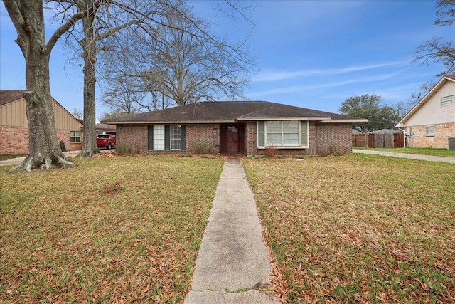 view of front facade with a front lawn and brick siding