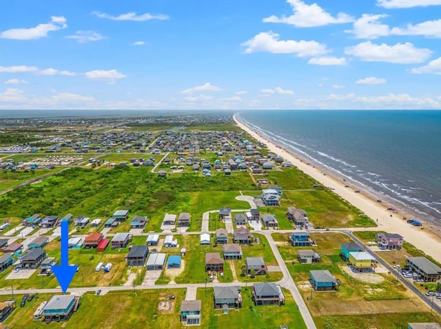 aerial view with a water view and a beach view