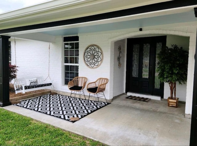 doorway to property featuring covered porch