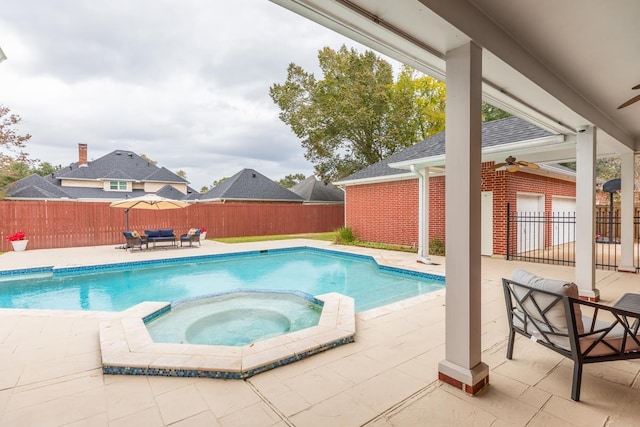 view of swimming pool featuring an in ground hot tub, ceiling fan, and a patio area