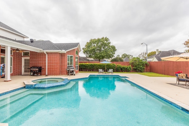 view of swimming pool featuring area for grilling, an in ground hot tub, and a patio