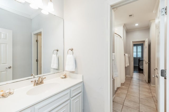 bathroom with tile patterned floors, vanity, and crown molding