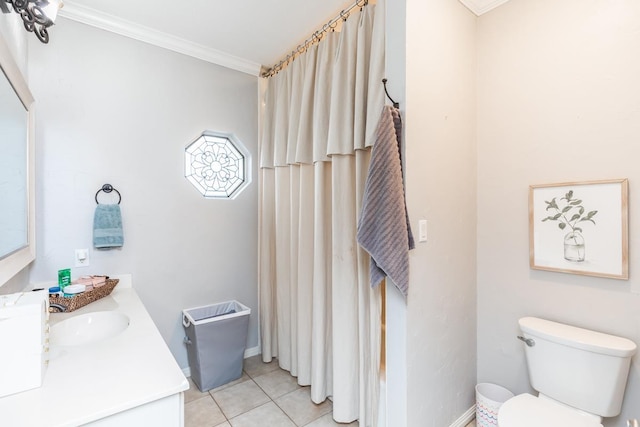 bathroom with tile patterned floors, vanity, toilet, and crown molding