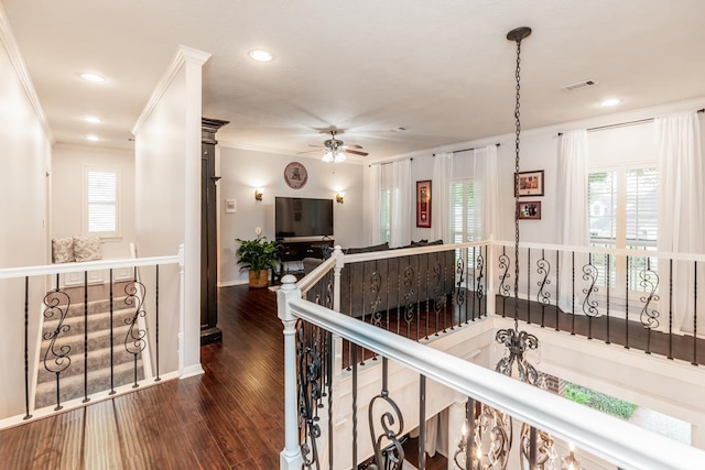 hall featuring ornamental molding, dark hardwood / wood-style flooring, and a healthy amount of sunlight