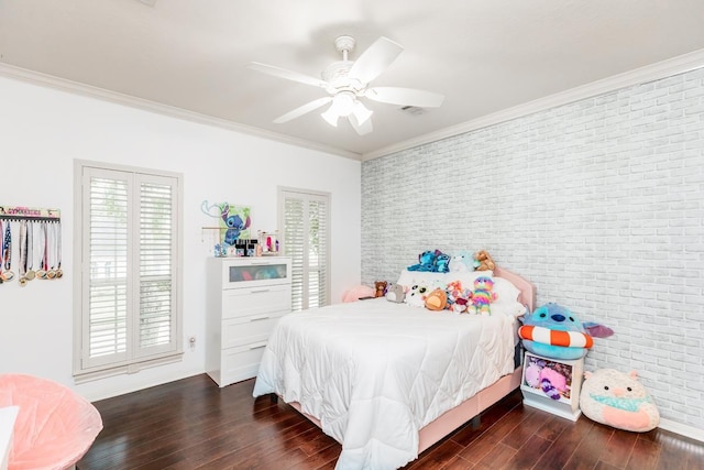 bedroom featuring crown molding, ceiling fan, dark wood-type flooring, and brick wall