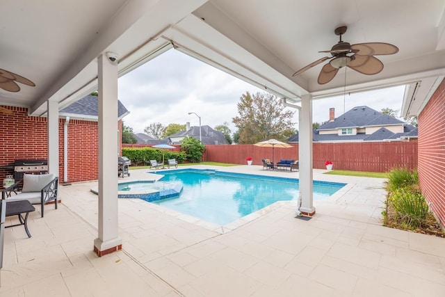 view of pool with ceiling fan, a patio, and grilling area