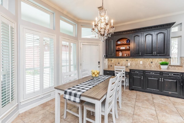 kitchen featuring light tile patterned floors, decorative light fixtures, ornamental molding, and a notable chandelier