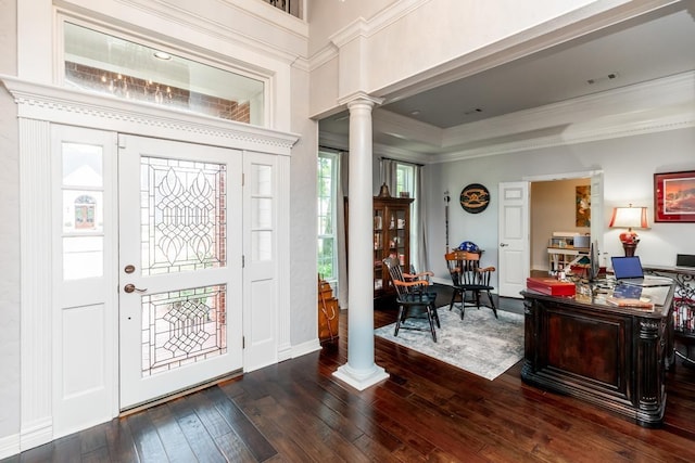 entrance foyer featuring decorative columns, dark wood-type flooring, and ornamental molding