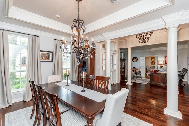 dining space with a notable chandelier, dark hardwood / wood-style floors, and decorative columns