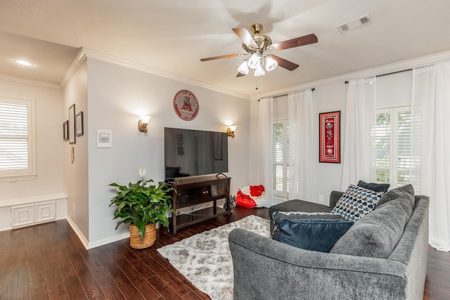 living room with ceiling fan, ornamental molding, and dark wood-type flooring