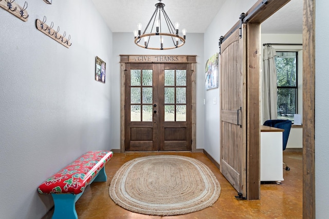 doorway to outside featuring a chandelier, french doors, a barn door, and a textured ceiling