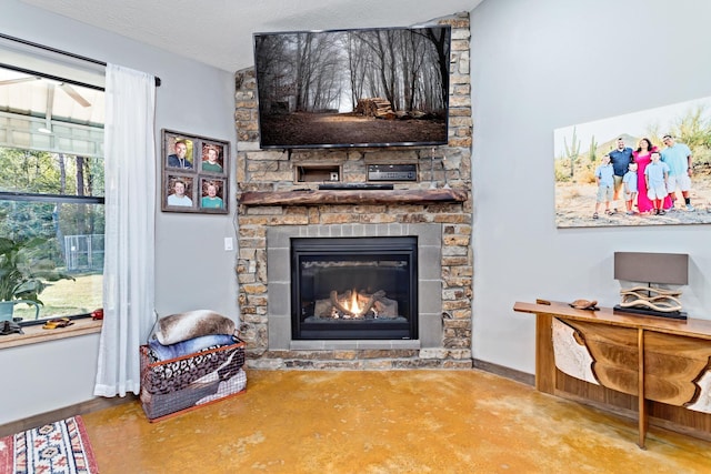 living room featuring a fireplace and a textured ceiling