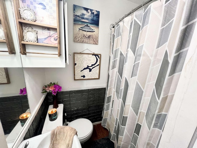 bathroom featuring toilet and wood-type flooring