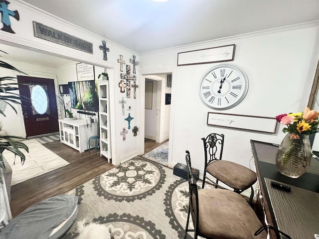 entryway with dark hardwood / wood-style flooring and ornamental molding