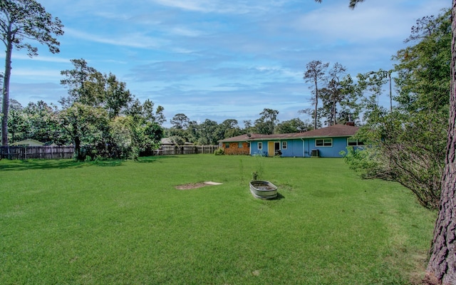 view of yard with a fire pit and a fenced backyard