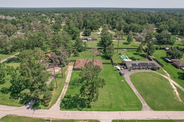 birds eye view of property featuring a forest view