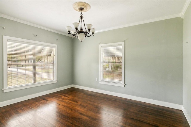 empty room featuring dark wood-type flooring, a chandelier, and ornamental molding