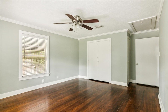 unfurnished bedroom with ceiling fan, dark hardwood / wood-style flooring, a textured ceiling, a closet, and ornamental molding