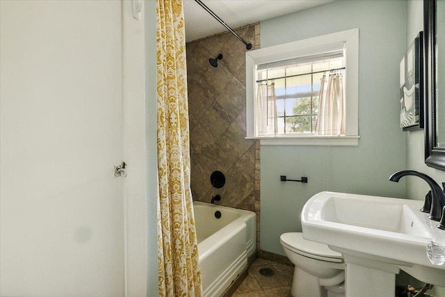 full bathroom featuring toilet, shower / tub combo, tile patterned floors, and sink