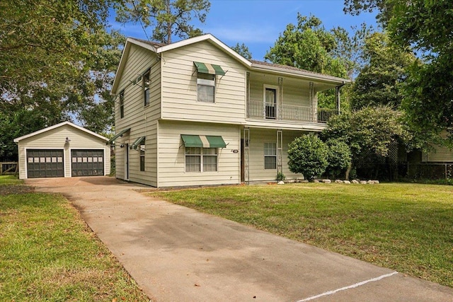 view of front of home featuring a balcony, a garage, a front lawn, and an outdoor structure