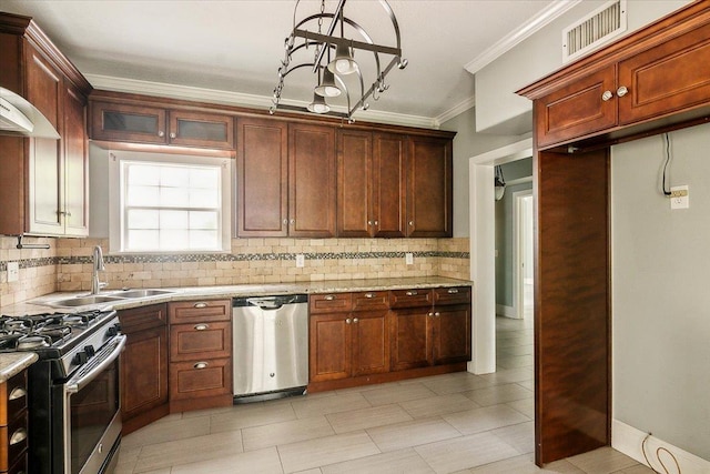 kitchen with appliances with stainless steel finishes, backsplash, light stone counters, and crown molding