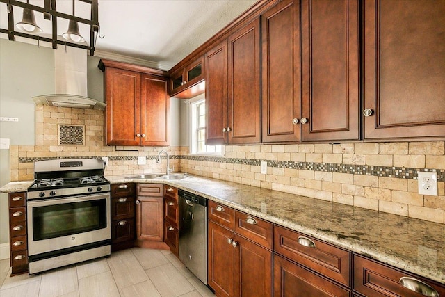 kitchen featuring decorative backsplash, light stone counters, sink, and appliances with stainless steel finishes