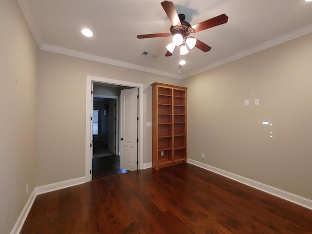 spare room with ornamental molding, dark wood-type flooring, and ceiling fan