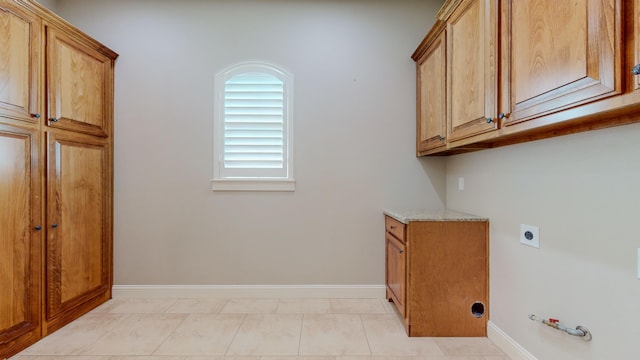 laundry area featuring cabinets and electric dryer hookup