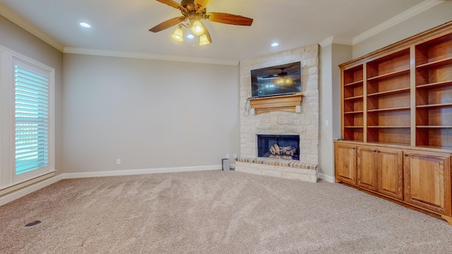 unfurnished living room featuring ornamental molding, a stone fireplace, light carpet, and ceiling fan