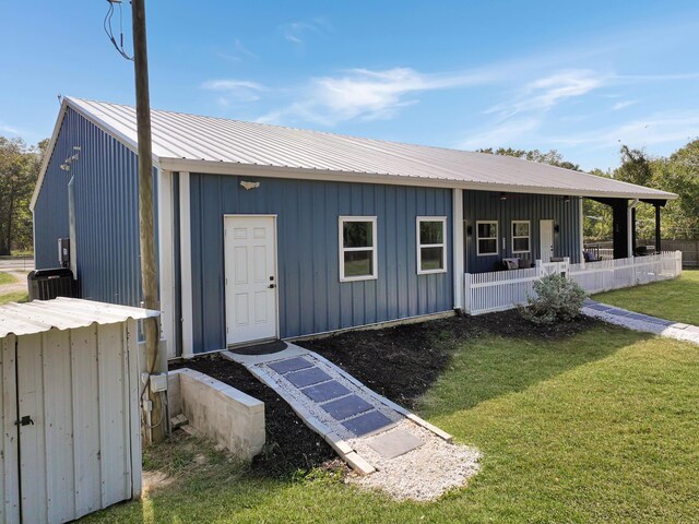 exterior space with covered porch and a yard