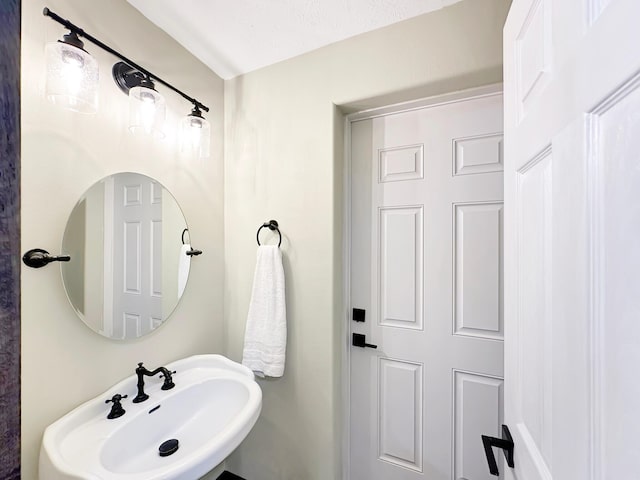 bathroom with sink and a textured ceiling