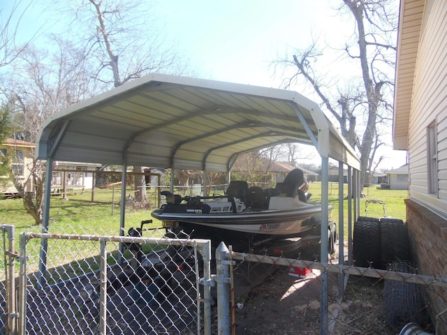 view of parking / parking lot with a gate, fence, and a detached carport