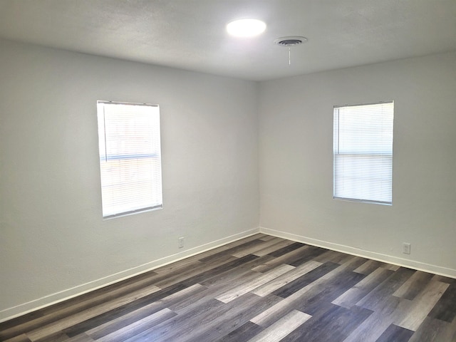 spare room featuring dark wood-type flooring